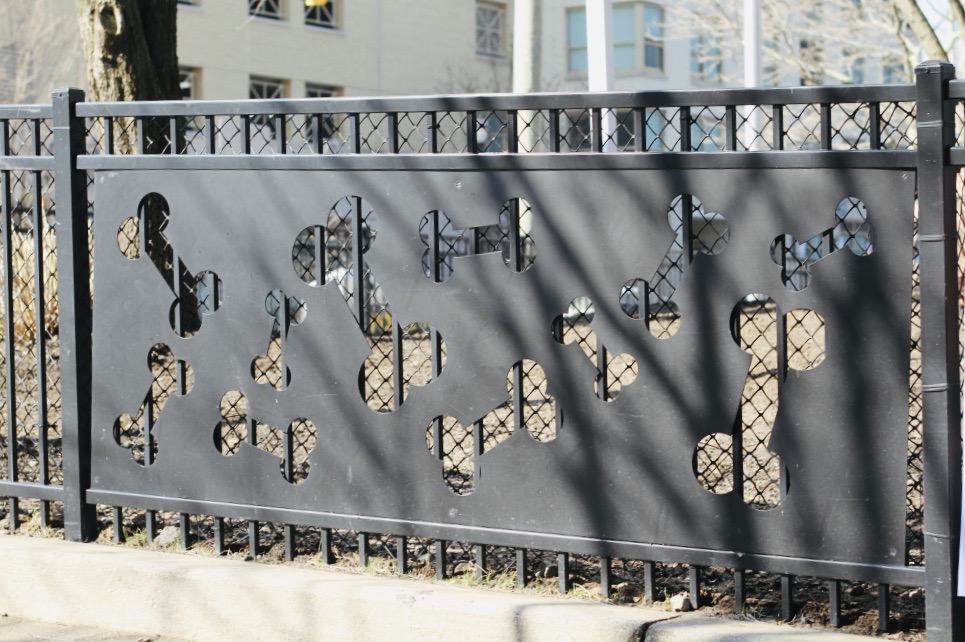 Iron fence with dog bone shapes.